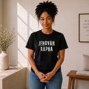 Woman wearing black "Jehovah Rapha" graphic t-shirt indoors